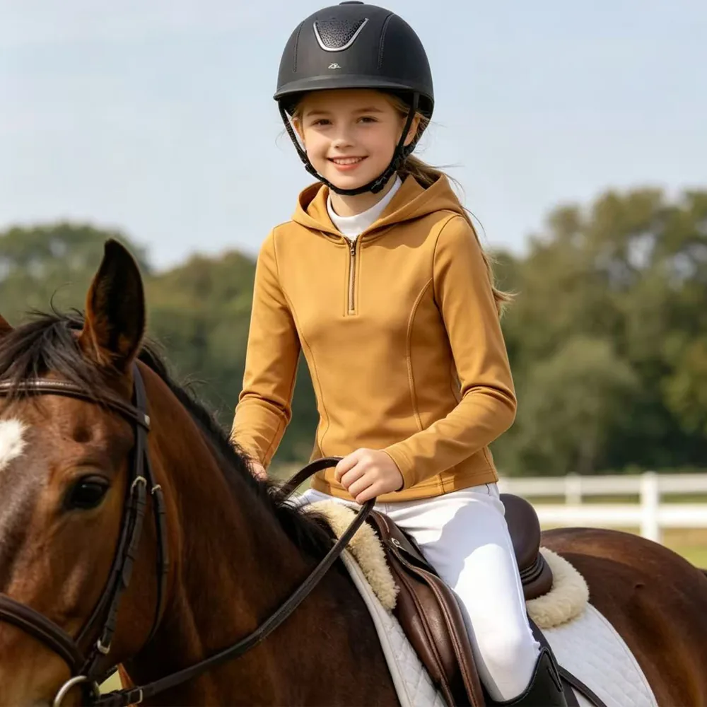 Young rider wearing equestrian apparel with a horse